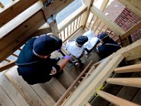 New Bedford EMT's Jacob Hughes and Rick Kalisz use a special chair to lower a patient who had collapsed due to low blood pressure, down the stairs to the waiting ambulance. Paramedic David Branco and Jason Kirby resuscitate an overdose patient in downtown New Bedford. Despite over 12,000 COVID-19 related calls since March, only one part-time EMT has tested positive for the virus.  PHOTO PETER PEREIRA