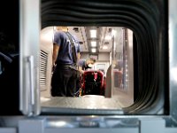 Seen through port between the driving cabin and the back of the ambulance, New Bedford EMT's Kevin Agrella and Ivan Britto tend ot a patient.  PHOTO PETER PEREIRA