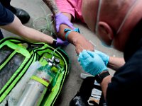 New Bedford EMS paramedic David Branco inserts an IV into an overdose patient in downtown New Bedford. Paramedic David Branco and Jason Kirby resuscitate an overdose patient in downtown New Bedford. Despite over 12,000 COVID-19 related calls since March, only one part-time EMT has tested positive for the virus.  PHOTO PETER PEREIRA