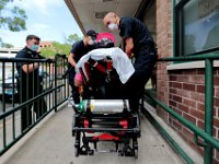 New Bedford police officer, Drew Frenette, who was first on the scene and administered nasal Narcan to an overdose patient, looks on as Jason Kirby and Bill Sullivan tend to the patient before placing him the ambulance. Paramedic David Branco and Jason Kirby resuscitate an overdose patient in downtown New Bedford. Despite over 12,000 COVID-19 related calls since March, only one part-time EMT has tested positive for the virus.  PHOTO PETER PEREIRA