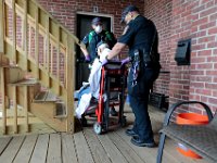 New Bedford EMT's Rick Kalisz and Jacob Hughes help a patient who had collapsed due to low blood pressure in downtown New Bedford. Paramedic David Branco and Jason Kirby resuscitate an overdose patient in downtown New Bedford. Despite over 12,000 COVID-19 related calls since March, only one part-time EMT has tested positive for the virus.  PHOTO PETER PEREIRA