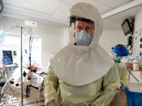 Wearing a PAPR hood, Dr. Hector Mateo keeps his eyes on the screen after installing a dyalisis catheter in a COVID-19 positive patient at the Charlton Memorial Hospital in Fall River.  PHOTO PETER PEREIRA