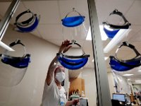 Kyla Sears RN, hangs up her assigned face shield after cleaning it at the Charlton Memorial Hospital in Fall River.  PHOTO PETER PEREIRA