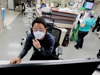 Dr. Brian Tsang checks patient x-rays on his computer at the Charlton Memorial Hospital in Fall River.  PHOTO PETER PEREIRA