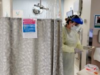 Nurse, Catelyn Dube emerges from a possible COVID-19 positive patient just admitted to the Charlton Memorial Hospital in Fall River.  PHOTO PETER PEREIRA