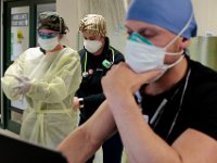 Nurses help each other get ready to check in with patients at the Charlton Memorial Hospital in Fall River.  PHOTO PETER PEREIRA