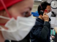 Dr. Brian Tsang, ED medical director, speaks on the phone at the Charlton Memorial Hospital in Fall River.  PHOTO PETER PEREIRA