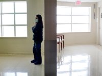 A nurse is bathed in light as she waits for the elevator at the Charlton Memorial Hospital in Fall River.  PHOTO PETER PEREIRA