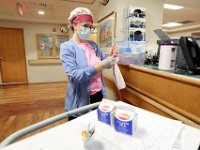 Melinda Botelho, RN,cleans her stethoscope before bringing some milk to a patient in the SK2 wing at PHOTO PETER PEREIRA