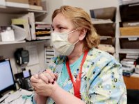 Wanda Johnson, lab clerk, cleans her hands after walking into the lab testing area at Tobey Hospital in Wareham.  PHOTO PETER PEREIRA