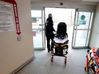 A Carver EMT wheels a stretcher through the emergency room entrance to Tobey Hospital in Wareham.  PHOTO PETER PEREIRA