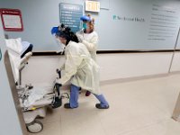 (l to r) Katelin Arruda, nurse tech, and Betty Chandler, RN wheel a newly admitted patient in the ER to a different room at Tobey Hospital in Wareham.  PHOTO PETER PEREIRA