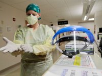 Nancy LoBue, RN, prepares to go into a room with a COVID-19 patient in the ICU at Tobey Hospital in Wareham.  PHOTO PETER PEREIRA]