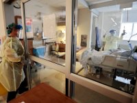 Nancy LoBue, RN, walks into a room with a COVID-19 patient in the ICU at Tobey Hospital in Wareham.  PHOTO PETER PEREIRA