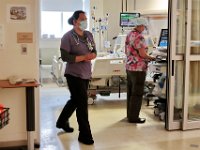 Eva Ko, RN walks out of a room as Paula St. Germain, respiratory tech, works on a patient at Tobey Hospital in Wareham.  PHOTO PETER PEREIRA