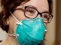 Sweat builds up on her glasses as Maria Joseph emerges after cleaning a room at Tobey Hospital in Wareham.  PHOTO PETER PEREIRA]