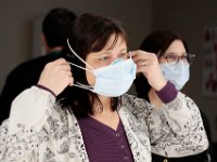 Andela Devoto, raiologic technologist, puts on two mask before x-raying a patient at Tobey Hospital in Wareham.  [ PETER PEREIRA/THE STANDARD-TIMES/SCMG ]