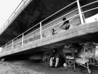 Max, 30, sits atop his possessions under the pedestrian overpass on Route 18 in the south end of New Bedford where he will live for the next few days.  Max and his girlfriend, who is also homeless, were forced out of an area where they had set up a tent at the Ben Rose Field Park. Once again, he and his girlfriend are looking for a place to call home.   PHOTOS PETER PEREIRA