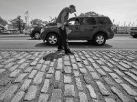 Robert Stone Jr. passes a motorist stopped at the traffic light as he panhandles at the intersection of Union Street and Route 18 in downtown New Bedford.  [ PETER PEREIRA/THE STANDARD-TIMES/SCMG ]