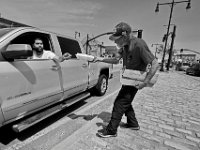 A motorist gives Robert Stone Jr. a box with breakfast that he didn't eat as Mr. Stone  panhandles at the intersection of Union Street and Route 18 in downtown New Bedford.  [ PETER PEREIRA/THE STANDARD-TIMES/SCMG ]