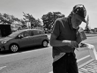Robert Stone Jr. eats a breakfast given to him for lunch as he panhandles at the intersection of Union Street and Route 18 in downtown New Bedford.  [ PETER PEREIRA/THE STANDARD-TIMES/SCMG ]