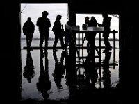 Seafood buyers from Asia, Europe, and the Middle East take in the view of the harbor from the boat unloading dock at the the BASE Seafood Auction house, during their visti to the area's leading seafood companies.  [ PETER PEREIRA/THE STANDARD-TIMES ]