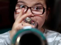 Aiyana Cortes, 10, looks for the right note while practicing her bugle with members of the Cape Verdean Drum ad Bugle Corps at the Verdean Vets Hall on Purchase Street in New Bedford.  [ PETER PEREIRA/THE STANDARD-TIMES ]