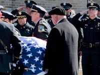 Police chief Joseph Cordeiro and fellow New Bedford police officers salute the casket of longtime New Bedford police officer Octavio C. "Tacky" Pragana, as it arrives for the Funerary Mass at St. Joseph-St. Therese Church on Acushnet Avenue in the north end of New Bedford.  [ PETER PEREIRA/THE STANDARD-TIMES ]