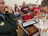 Surrounded by his family, Alfred William Sylvia Jr. 98, looks on as Christopher Azevedo, a veteran of the Navy during Desert Storm, and Army specialist in Iraq, becomes emotional after Mr. Sylvia spoke about a close friend he lost when the USS Dortch was attacked while in Tokyo Bay.  Mr. Azevedo became emotional because he too lost close friends while serving in Iraq in 2005. Mr. Sylvia's daughter Dorothy Manny, right, listens to the stories of both men.  Mr. Azevedo who is the president of the Operation Uniforms United organization which helps veterans was instrumental in having Mr. Sylvia re-awarded his medals at a service held at Oxford Terrace in Fairhaven [ PETER PEREIRA/THE STANDARD-TIMES/SCMG ]