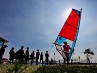 Participants look on as windsurfing instructor Jim DeSilva explains how to steer a windsurfer during the new Community Boating Center windsurfing program held in Clarks Cove in the south end of New Bedford.  [ PETER PEREIRA/THE STANDARD-TIMES/SCMG ]
