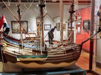 A visitor to the Whaling Museum in New Bedford, takes a closer look at one of the many paintings on display in the new 'De Wind is Op' exhibit featuring Dutch maritime paintings, as seen through the model of a Dutch whaleship dating to the 17th century. PHOTORAPHER NOTE: Never hurts to walk into the Whaling Museum to see what is new inside.  In this case a Dutch painting exhibit.  Ill tell you this much, the curators at the Whaling Museum put on world class shows, and for a guy with a camera, that equals great photos waiting to happen.  I was in this particular exhibit for about 20 minutes when I noticed a visitor really going through every single piece hanging on the wall, and taking the time to read the cards describing the piece.  I noticed the model of an old Dutch whaleship in the foreground and just waited until he moved into one of the paintings between the masts. Notice how you can see all of the paintings in the background between the masts of the model?  Yes, I thought of that as I positioned myself behind the model.  Every centimeter counts! [ PETER PEREIRA/THE STANDARD-TIMES/SCMG ]