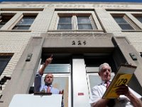 Justin J. Manning of JJ Manning Auctioneers, announces the winner as Edward Benson, right, registers the winning bid for the old Sunbeam Bread factory on Coffin Avenue in New Bedford.  The building sold for $178, 200.  PHOTORAPHER NOTE: The smell of fresh bread is something those of us who were around when the Sunbeam Bread plant was in full operation, will never forget.  Fifteen years after it officially closed (which of course I covered the last day...) the north end structure was coming under the auction hammer.  I decided to place myself just in front of the auctioneer, in a low position so that the building could be more identifiable with the name running across the top, and somewhat more graphic in the state of disrepair it has fallen under.  It was only a matter of time before the winning bid was put in, and the trick was to get the moment.  There it was. [ PETER PEREIRA/THE STANDARD-TIMES/SCMG ]