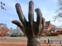 A couple going for a walk around Buttonwood Park on a cold morning, make their way past the hand reaching for the sky atop the Holocaust Memorial on Rockdale Avenue, in New Bedford.  [ PETER PEREIRA/THE STANDARD-TIMES/SCMG ]