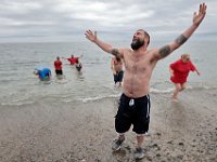 James O'Driscoll, brother of Shannon, screams into the sky after diving into the cold waters off of Goosebury Island in Westport, MA on November 27, 2019, for the annual Plunge of the Faithful in celebrating the life of Shannon O'Driscoll who was killed in 2006 by an SUV driver while holding a sign supporting organized day care programs in the state. This is part of a fundraiser, which has raised over 20K dollars since it began.