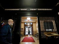 New Bedford City Hall elevator operator, Lane Wood, left, waits for someone to take a ride aboard one of the oldest (1906) running elevators in the country, as someones leaves City Hall.  [ PETER PEREIRA/THE STANDARD-TIMES ]