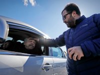 Rev. Scott Ciosek offers a prayer and ashes to Barry Starr and his wife Nancy Starr, along with any other motorists who drive up in the parking lot of the St. Peter's Episcopal Church on County Street in New Bedford as part of his Ashes to Go program on ash Wednesday.  [ PETER PEREIRA/THE STANDARD-TIMES ]