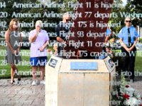 A woman wipes a tear as seen through a pane of glass etched with the events of September 11, 2001, during a ceremony held at the 9/11 memorial in front of the Acushnet Fire Station at the intersection of Main Street and Russell Street in Acushnet.  A beam from the World Trade Center can be seen in the center of the photo.  [ PETER PEREIRA/THE STANDARD-TIMES/SCMG ]