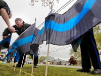 Wareham police officers place 165 Thin Blue Line flags in front of the Wareham Police Station on Cranberry Highway in Wareham in remembrance of 163 officers who died in the line of duty in 2018, and 2  for the two Wareham police officers who were killed in the line of duty (one in 1999 and one in 1932).  [ PETER PEREIRA/THE STANDARD-TIMES/SCMG ]