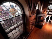 Whaling Museum visitors are seen walking the third floor, as workmen re-caulk the windows of the iconic downtown New Bedford museum as part of a extensive exterior repair project.   [ PETER PEREIRA/THE STANDARD-TIMES/SCMG ]