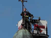 New Bedford firefighter Mike Cabral, works on removing the cross from the top of the Saint Anne church's steeple, before it is demolished laters this week to make way for a Public Safety Center.  [ PETER PEREIRA/THE STANDARD-TIMES/SCMG ]