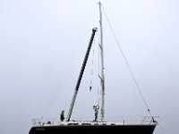 Brownell Systerm workers rig a sailboat to put in the water, on a foggy morning in Mattapoisett.  [ PETER PEREIRA/THE STANDARD-TIMES/SCMG ]