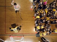 Students look on as a teacher celebrates scoring a goal on Blades the Boston Bruins mascot during his visit to the Holy Family Holy Name school as part of the Boston Bruins Fit School Assembly Program.  The Boston Bruins donated a hockey sticks, nets and goalie gear to the schoo  [ PETER PEREIRA/THE STANDARD-TIMES ]