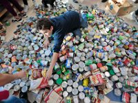 Eighth grader Nikolas Santiago, 14, reaches for a bag of rice to hand to his classmate, as he and fellow Normandin Middle School students sort and prepare food baskets to give to the needy for Thanksgiving, with cans they collected throught the school year.   [ PETER PEREIRA/THE STANDARD-TIMES/SCMG ]