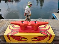 Port of New Bedford launch driver, Bob Clarkson, walks past a cleat on the dock painted into a crab in front of the visitors center on Fisherman's Wharf.  [ PETER PEREIRA/THE STANDARD-TIMES/SCMG ]