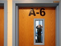 Shannon Smith is seen combing her hair, through the window of her cell door in the women's wing of the Birstol County House of Correction in Dartmouth.  [ PETER PEREIRA/THE STANDARD-TIMES/SCMG ]