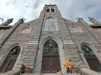 Jane Paul volunteers her time to add a touch of autumn to the front of Our Lady of Guadalupe Parish at St. James Church on County Street in New Bedford.  [ PETER PEREIRA/THE STANDARD-TIMES/SCMG ]