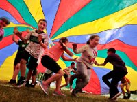 Charles Ashley Elementary School fourth graders have a great time running under a colorful parachute, during Field Day outside their school in the north end of New Bedford.  [ PETER PEREIRA/THE STANDARD-TIMES/SCMG ]