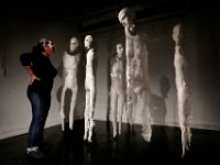 Paulina Fuenzalida works on installing her art project entitled 'Glint', to be evaluated by professors on Wednesday at the UMass Dartmouth Center of Visual and Performing Arts in downtown New Bedford, as part of her Master in Fine Arts degree final.  The piece is made up of mannequins she made using cotton, connected by fishing line, with glimmer, to create a layer of interaction between the mannequins and the viewer.   [ PETER PEREIRA/THE STANDARD-TIMES/SCMG ]