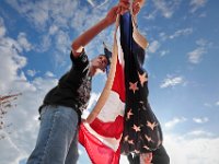 John Mills, 15, and fellow New Bedford High School JROTC students hoist the American flag in front of their school, a ritual they perform every morning before school starts.   [ PETER PEREIRA/THE STANDARD-TIMES/SCMG ]