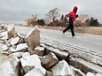 A man braves the weather to go for a run atop the hurricane barrier at Fort Phoenix in Fairhaven.  [ PETER PEREIRA/THE STANDARD-TIMES/SCMG ]